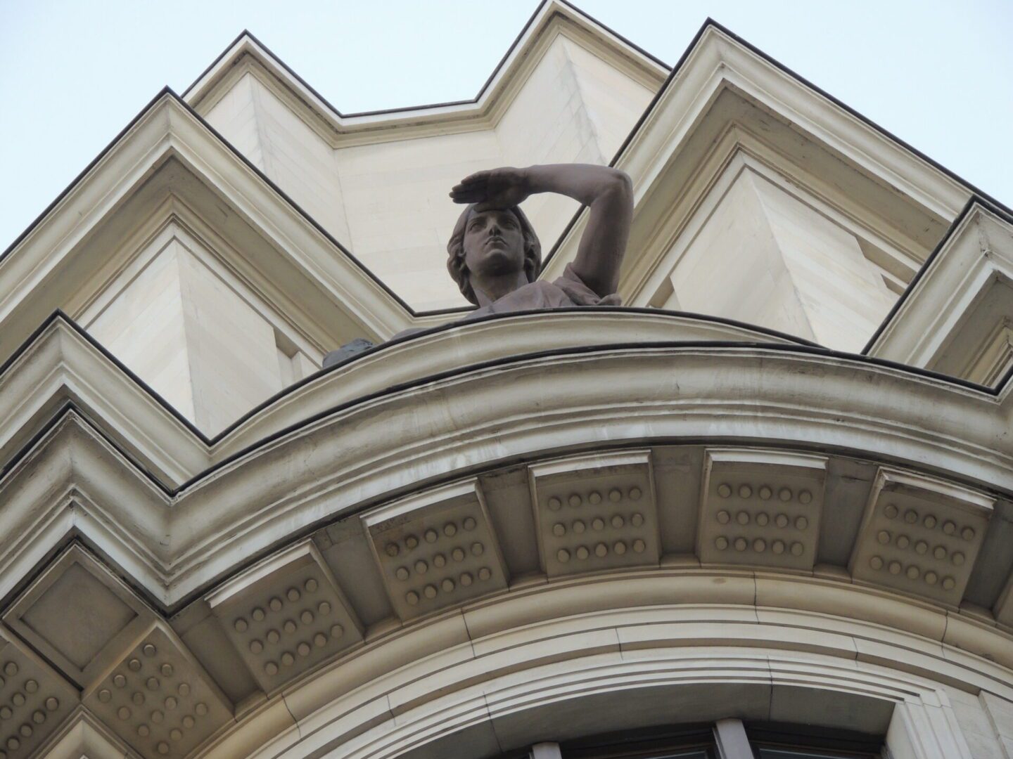 A statue of a person on top of a building.