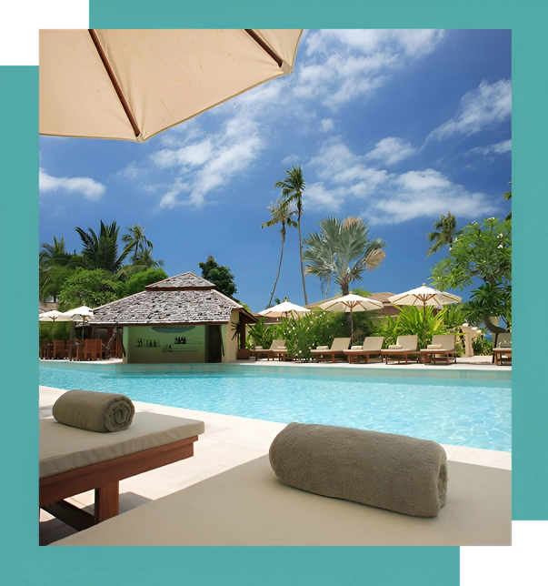 A pool with umbrellas and chairs next to it