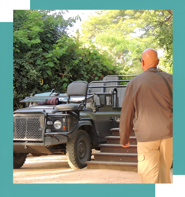 A man walking up steps next to an army vehicle.