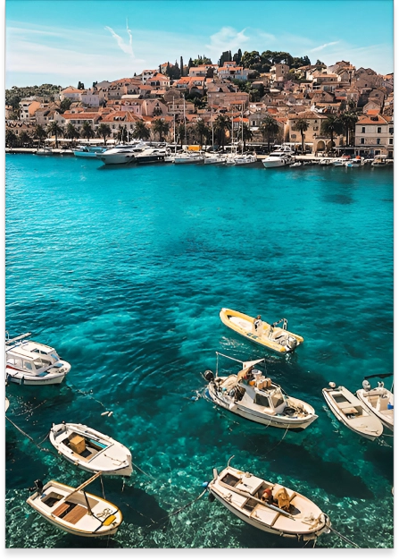 A group of boats floating on top of a body of water.