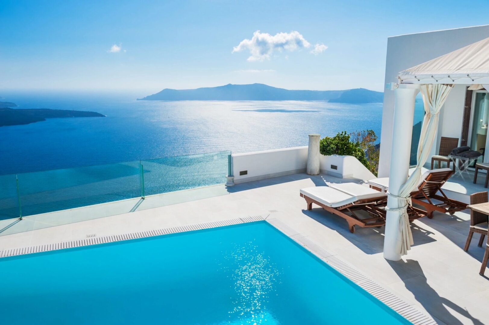 A pool with an ocean view and a deck.